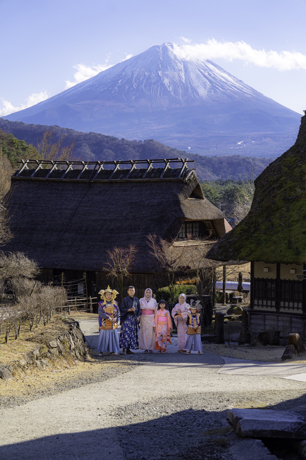 Family wearing kimono with Mount Fuji in the background